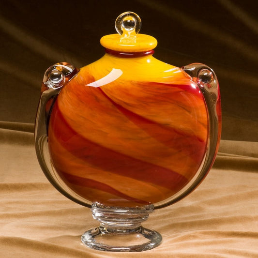 Hand Blown Glass Urn with orange, yellows and reds.